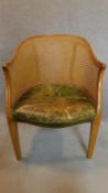 A green leather upholstered tub bergere armchair. H.87cm