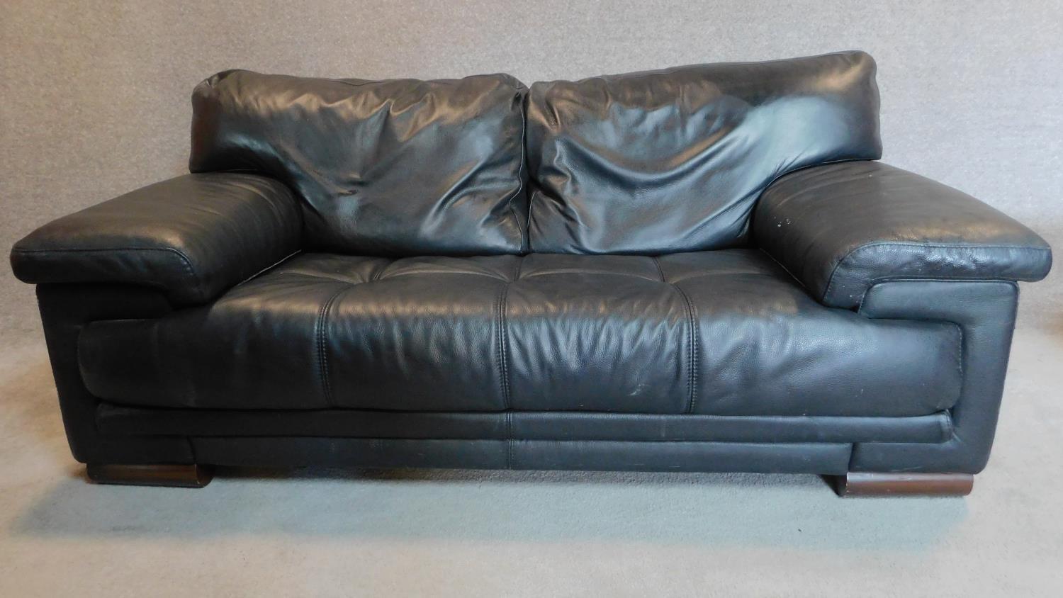 A black leather 2 seater sofa with buttoned seat and matching footstool. 75x179x98cm (sofa) - Image 3 of 10