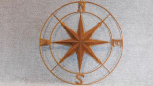 A large decorative metal compass. 104x104cm