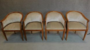 A set of four teak framed tub chairs. H.85cm