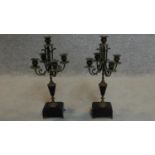 A pair of late 19th century brass five sconce candelabra on slate bases raised on brass paw feet.