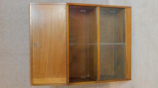 A vintage teak bureau with fitted interior and sliding glass front doors. 100x76x26cm