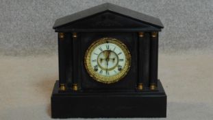 A late Victorian black slate mantel clock with enamel dial in classical style architectural case.