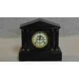 A late Victorian black slate mantel clock with enamel dial in classical style architectural case.