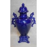 A blue glazed lidded twin handled urn of shaped bulbous form. H.65cm