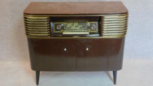 A 1960's vintage German radio and record player. 83x96x41cm (one leg loose)
