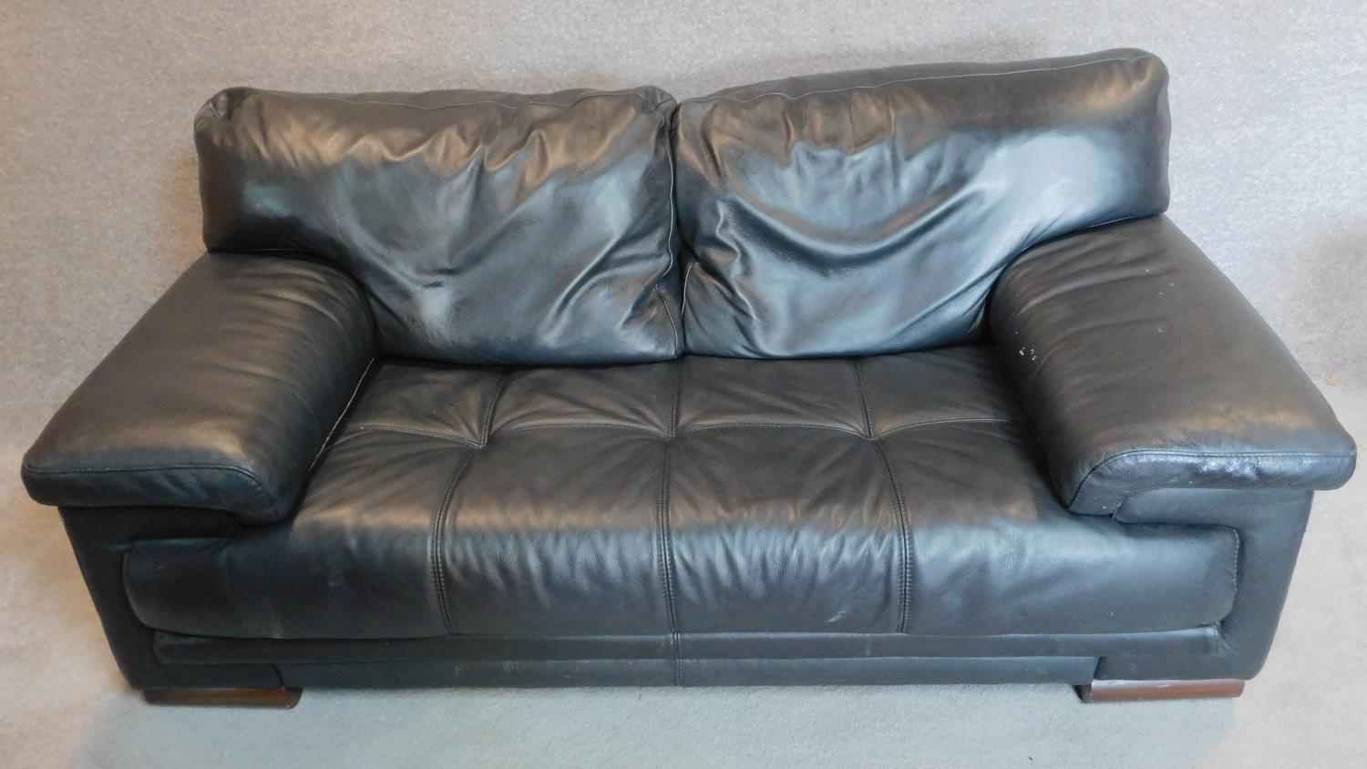 A black leather 2 seater sofa with buttoned seat and matching footstool. 75x179x98cm (sofa) - Image 2 of 10