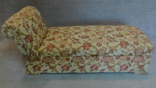 An Edwardian floral upholstered ottoman or day bed with adjustable reclining action. 40x185x68cm