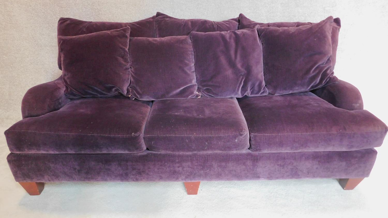 A Victorian style three seater sofa in purple velvet upholstery, makers label: Bernhardt.