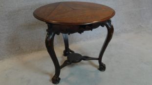 A 19th century Continental carved oak swivel action trefoil flap centre table. 74x82x82cm