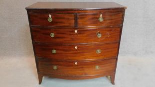 A Georgian mahogany bowfronted chest of two short over three long drawers on swept bracket feet.