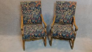 A pair of beech framed French provincial style armchairs in floral tapestry upholstery. H.118cm