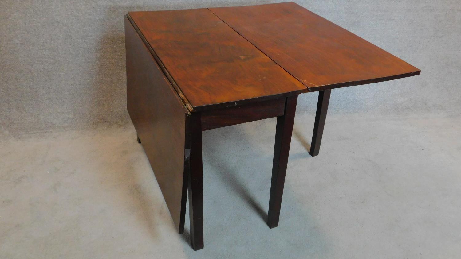 A Georgian mahogany drop flap dining table on square section supports. 73x148x99cm - Image 3 of 5