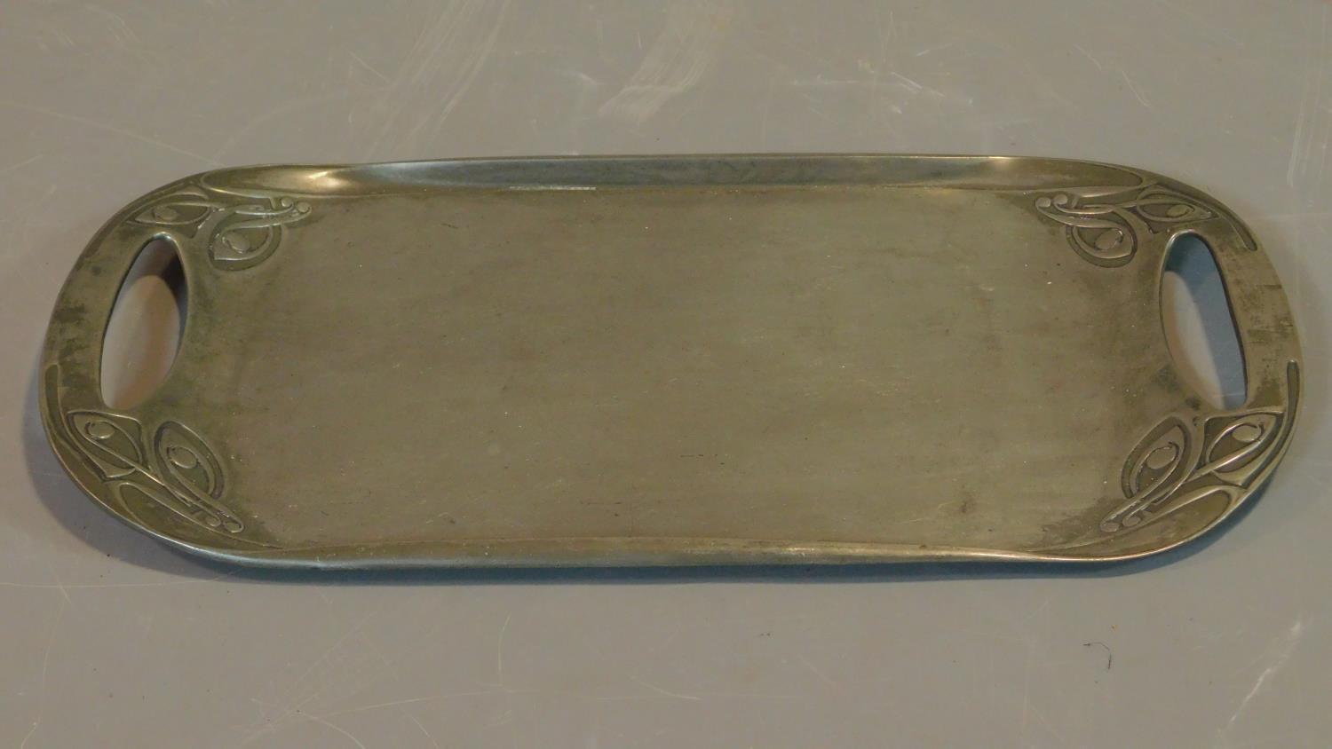 A Tudric for Liberty's Archibald Knox design twin handled pewter tray. 47x26cm
