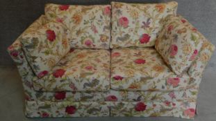 A floral upholstered two seater sofa. 74x160x88cm