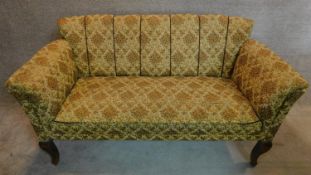 An Edawrdian sofa in original floral tapestry style upholstery on mahogany cabriole supports.