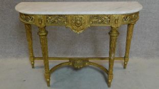 A carved giltwood marble topped console table in the Louis XVI style. 80x122x44cm