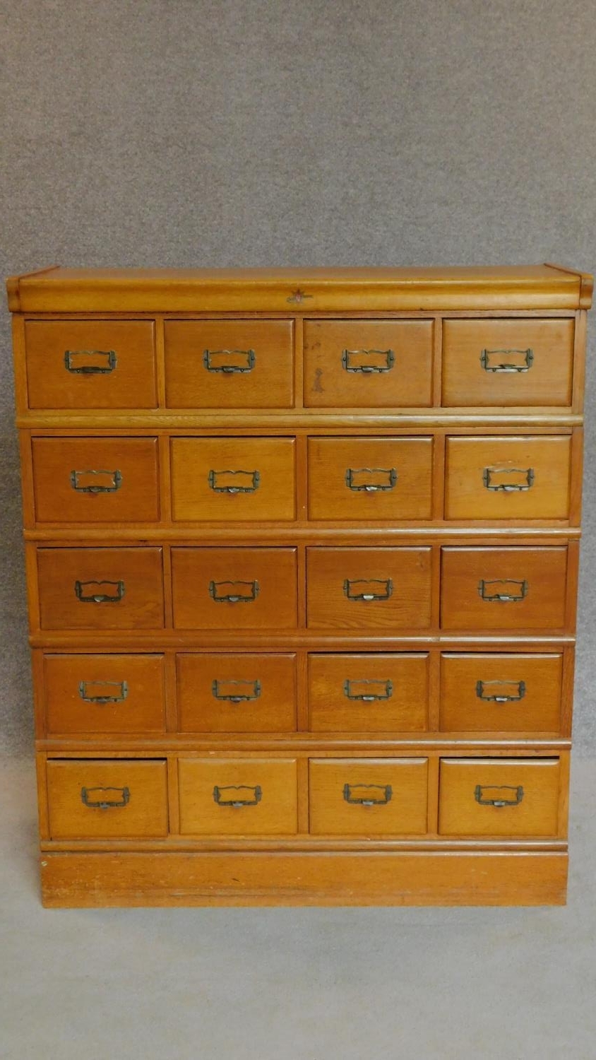 An American oak seven section (including plinth base and top) filing cabinet by Kenrick and