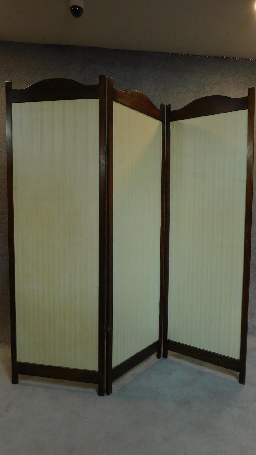 An Edwardian full height oak framed two fold, three panel screen fitted striped solid panels H.183cm