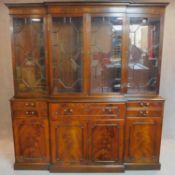 A Georgian style mahogany two section breakfront library bookcase with well fitted central