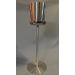 A brushed chrome Alessi ice bucket on stand. H.81cm