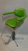 A chrome framed barber's style chair in emerald green vinyl upholstery. H.95cm