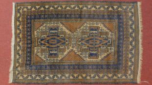 A Belouch rug with central double pole medallion set on a blue, ivory and yellow field with