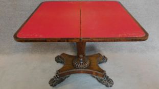 A Regency rosewood foldover top card table with baize lined interior on well carved pedestal and