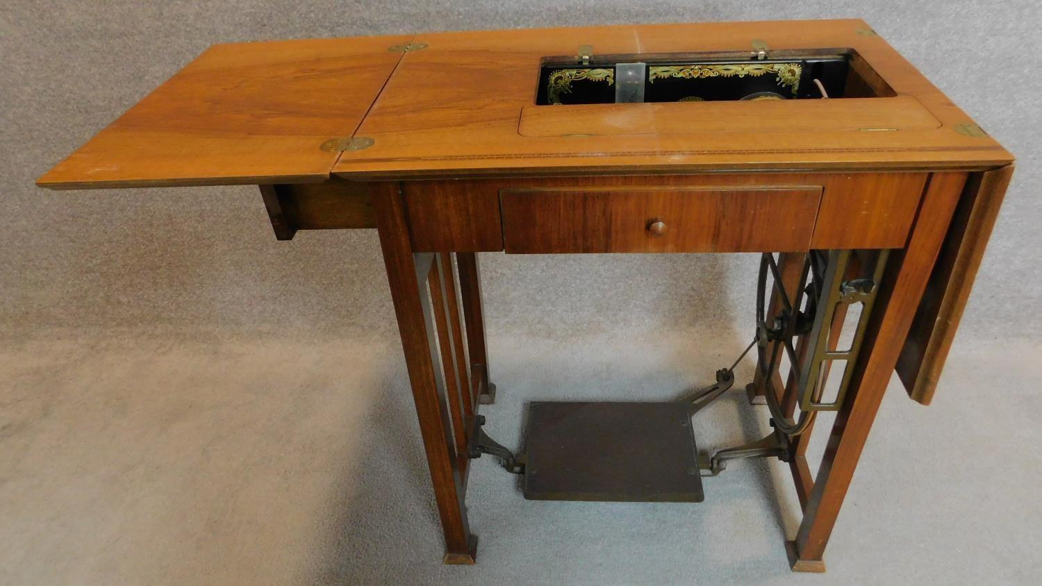 A vintage Frister and Rossman sewing machine in a fitted walnut side table. 80x70x50cm - Image 3 of 9