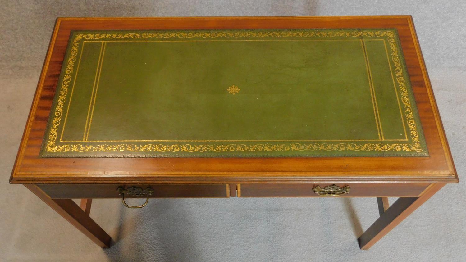A Sheraton style mahogany and inlaid two drawer writing table on reeded square section stretchered - Image 3 of 7