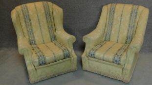 A pair of striped upholstered armchairs. H.88cm