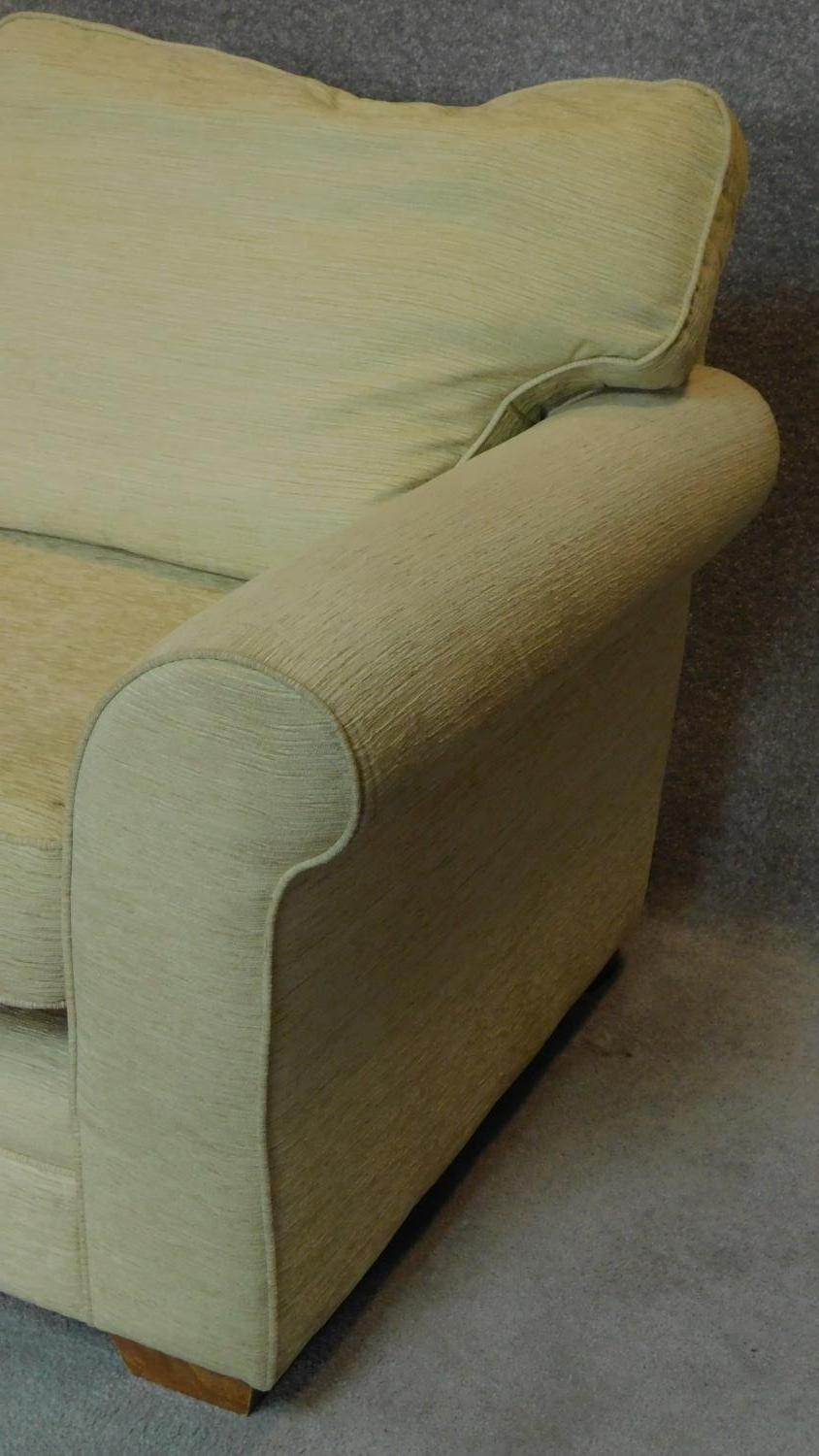 A two seater sofa in cream upholstery. 70x175x90cm - Image 3 of 4