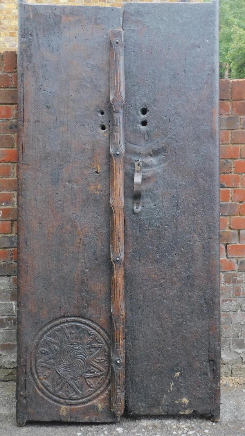 A pair of antique carved doors from the Kafiristan region of Afghanistan. 215x100cm