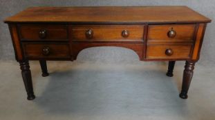 An early 19th century mahogany writing table with satinwood and ebony lined top on spiral reeded