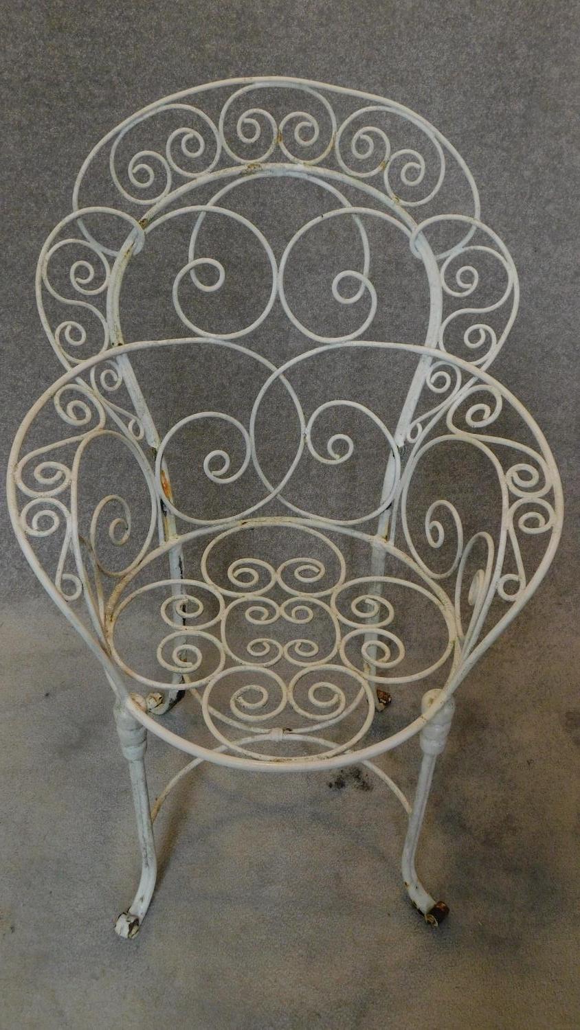 A pair of wrought iron and painted shaped back garden armchairs. H.104cm - Image 3 of 3