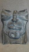 A large lead floor standing sculpture portrait of a mans face. 100x80cm