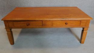 An Eastern teak low table fitted frieze drawers. 46x124x63cm