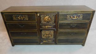 A lacquered and carved Chinese sideboard fitted central cupboard flanked by drawers. 90x180x45cm