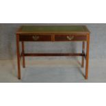 A Sheraton style mahogany and inlaid two drawer writing table on reeded square section stretchered