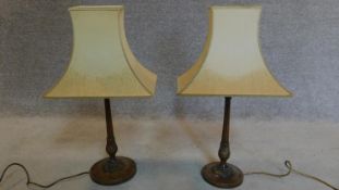 A pair of mahogany carved and gilded table lamps. H.62cm