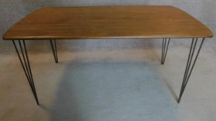 An oak topped dining table on hairpin supports. 73x155x77cm