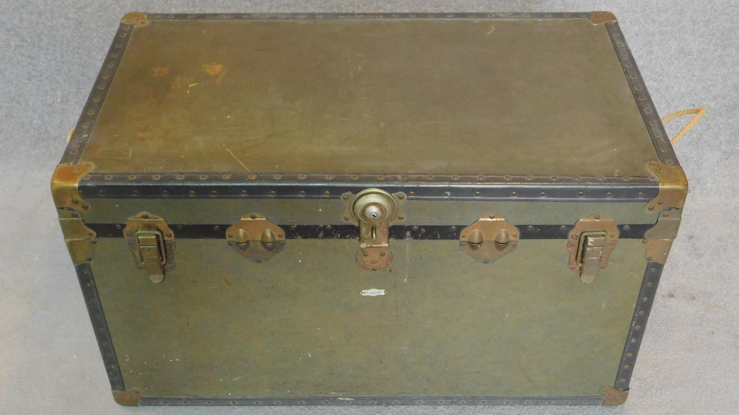 A vintage brass and leather bound hinged cabin trunk. H.49 W.91 D.51cm