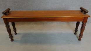 A late Victorian walnut window seat with turned supports. H.50 W.119 D.27cm