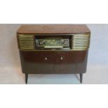 A 1960's vintage German radio and record player. 83x96x41cm (one leg loose)