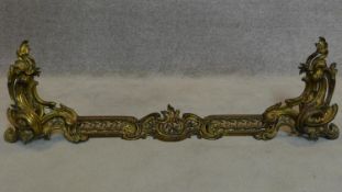 A 19th century French adjustable fire kerb with Rococo style chenets. W.135cm
