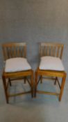 A pair of teak framed side chairs with squab cushions. H.98cm