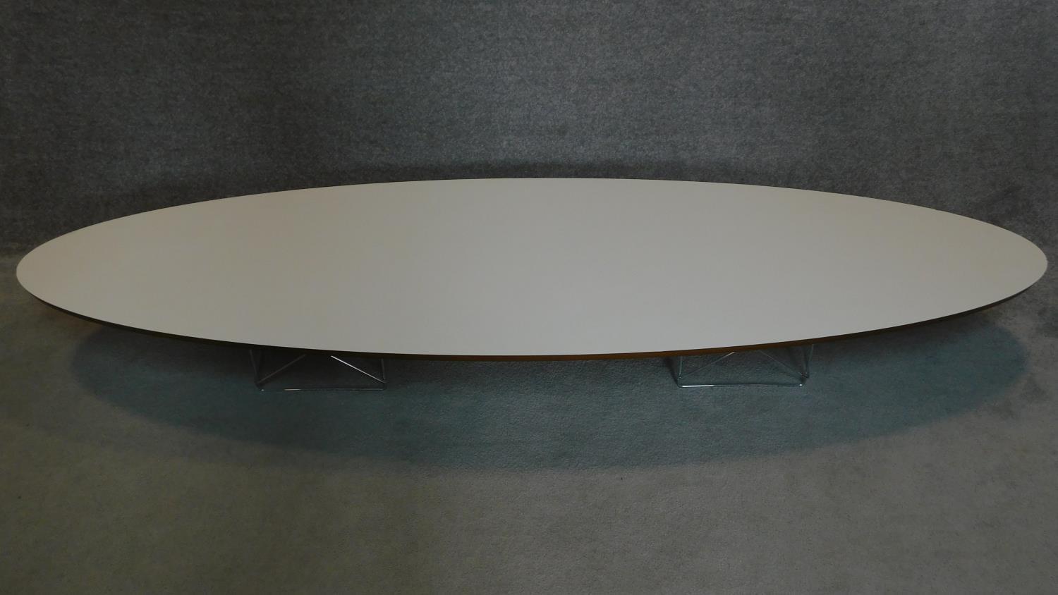 A long oval low coffee table, The Eames Table by Vitra, label to underside. 25x227x75cm