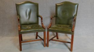 A pair of Georgian style mahogany Gainsborough chairs in green leather upholstery. H.105cm