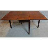 A Georgian mahogany drop flap dining table on square section supports. 73x148x99cm