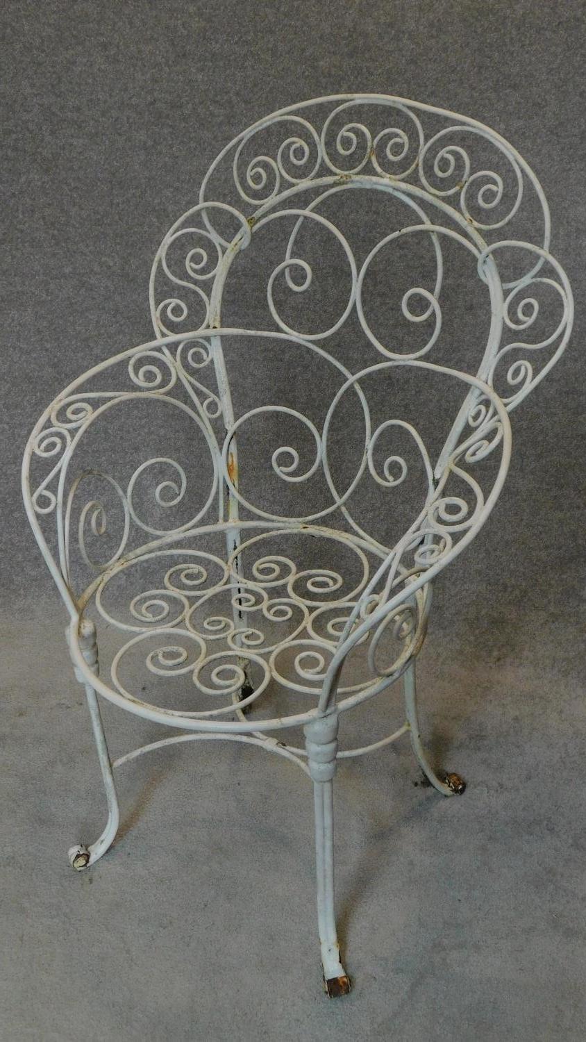 A pair of wrought iron and painted shaped back garden armchairs. H.104cm - Image 2 of 3